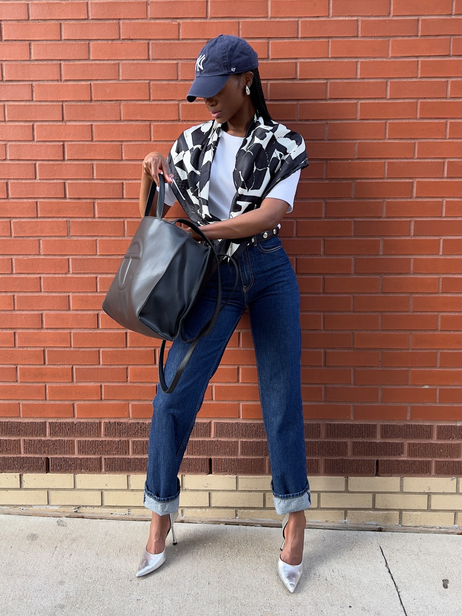 S P O R T Y   C H I C
My take on how to dress up a simple white tee and jeans. I LOVE pairing a more relaxed look with heels to elevate the look. 

The bag is from Telfar - Medium Black tote