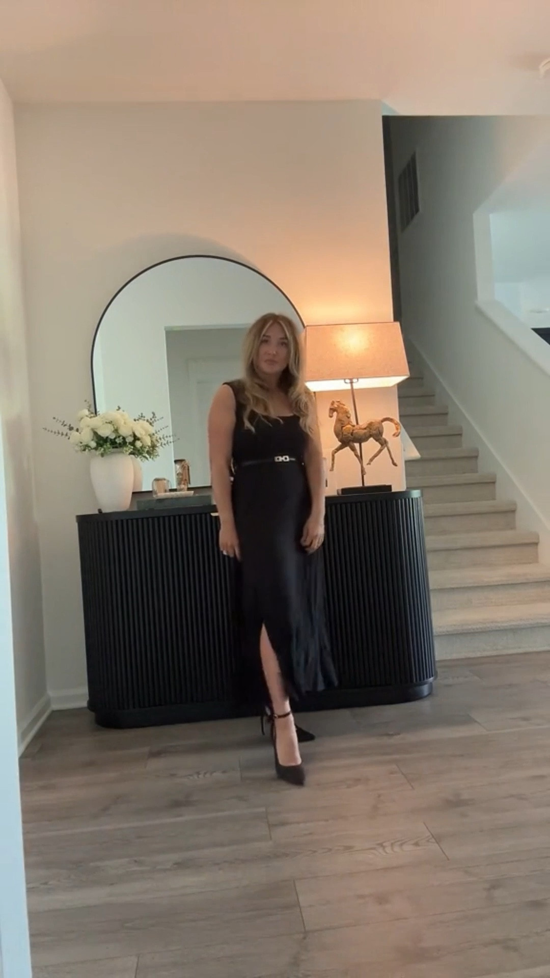 Channeling that timeless Parisian elegance—in both my outfit and my entryway.

This black belted midi dress is one of those pieces that just works:
✔️ Flattering
✔️ Effortless
✔️ Put-together with zero fuss

I paired it with classic black heels and soft waves for a look that feels equally chic for a dinner out or hosting at home.

And can we talk about this decor moment? The arched mirror, sculptural lamp, and floral arrangement bring that refined, minimalist je ne sais quoi that makes me feel like I’m living in a little Paris apartment—right here in Florida.

Everything I’m wearing and styling is linked for you here. 

#ParisianStyle #ChicAtHome #LTKHome #LTKFashion #SoftAutumnStyle #PetiteStyle #BlackDressMoment #FrenchGirlVibes #InteriorInspo #ParisianDecor #CapsuleCloset #EntrywayGoals

#LTKPetite #LTKHome #LTKFindsUnder50