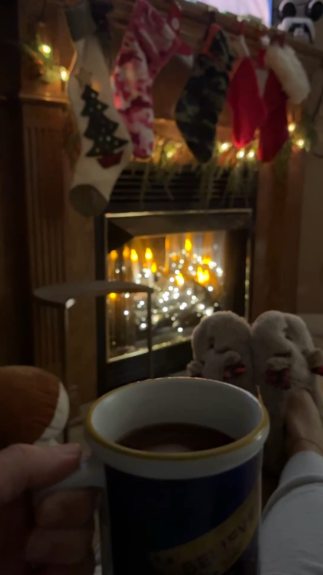 Instant cozy on a non working fireplace: twinkle lights and battery operated candles. Festive slippers and hot chocolate make for a perfect Christmas season movie night. 

#LTKHoliday