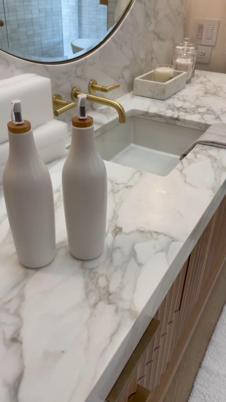 Get creative with dispensers! A great way to store mouthwash to give your bathroom countertop an elevate look! The Modern Muse Bathroom organization and functional decor 

#LTKhome #LTKVideo