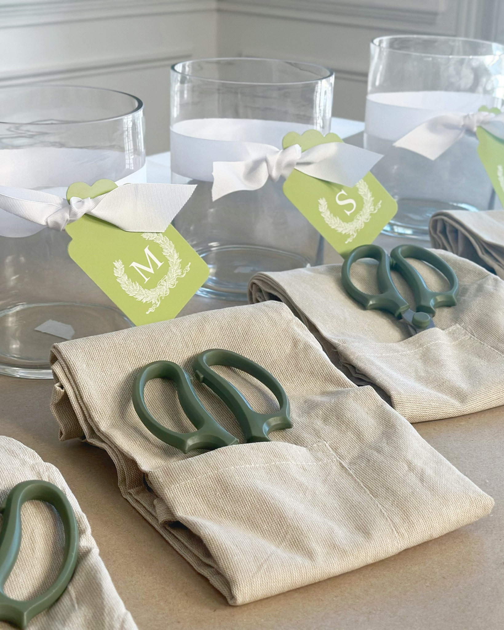 We hosted a floral arranging party this spring! At each seat, Julie had thoughtfully placed a glass vase, tied with white grosgrain ribbon and finished off with a personalized leaf-green Savannah wreath gift tag, giving each vase a unique, personalized touch. The ladies were also gifted linen aprons to keep their clothes clean as well as a pair of garden scissors

https://southernhospitalityco.com/2025/03/07/blooming-creativity-a-floral-arranging-party/

#LTKParties #LTKHome #LTKSeasonal