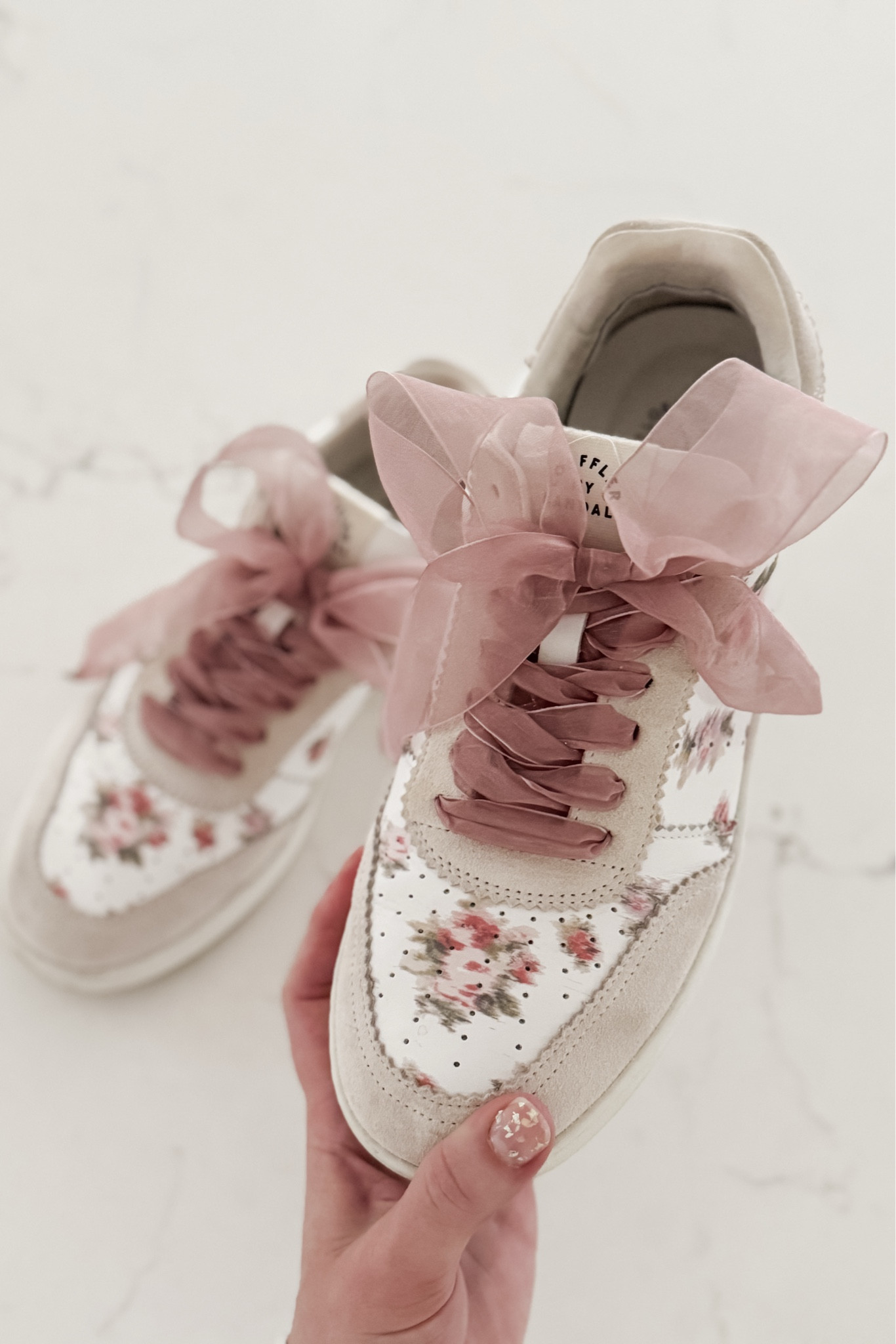 Comfort is my number one priority for the #ErasTour but I also want to be on-theme! I’ve had these Loeffler Randall printed Keeley sneakers for a few years and they seemed like the perfect choice for my “Lover” Era inspired outfit! 

I replaced the white laces with some sheer dusty pink ribbon laces to make them even more fun! 
*(I used the 55” length)

Another cute idea would be to thread “friendship bracelet” beads and charms onto the laces! 