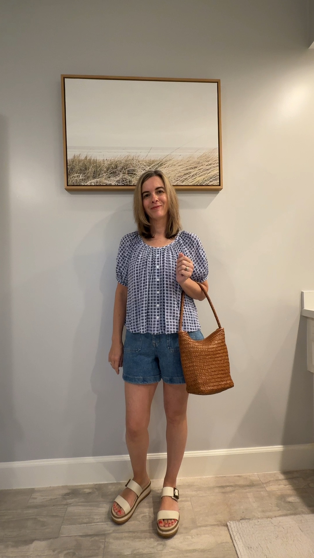 I’m wearing a flowy short sleeve summer top with Madewell denim shorts. I styled this outfit with wedge sandals and a stylish woven purse to got with it. This summer outfit with its dressy style is great for a dinner date night outfit, vacation outfit, or any summer outing for a dressy look.

#LTKootd #LTKOver40 #LTKPetite