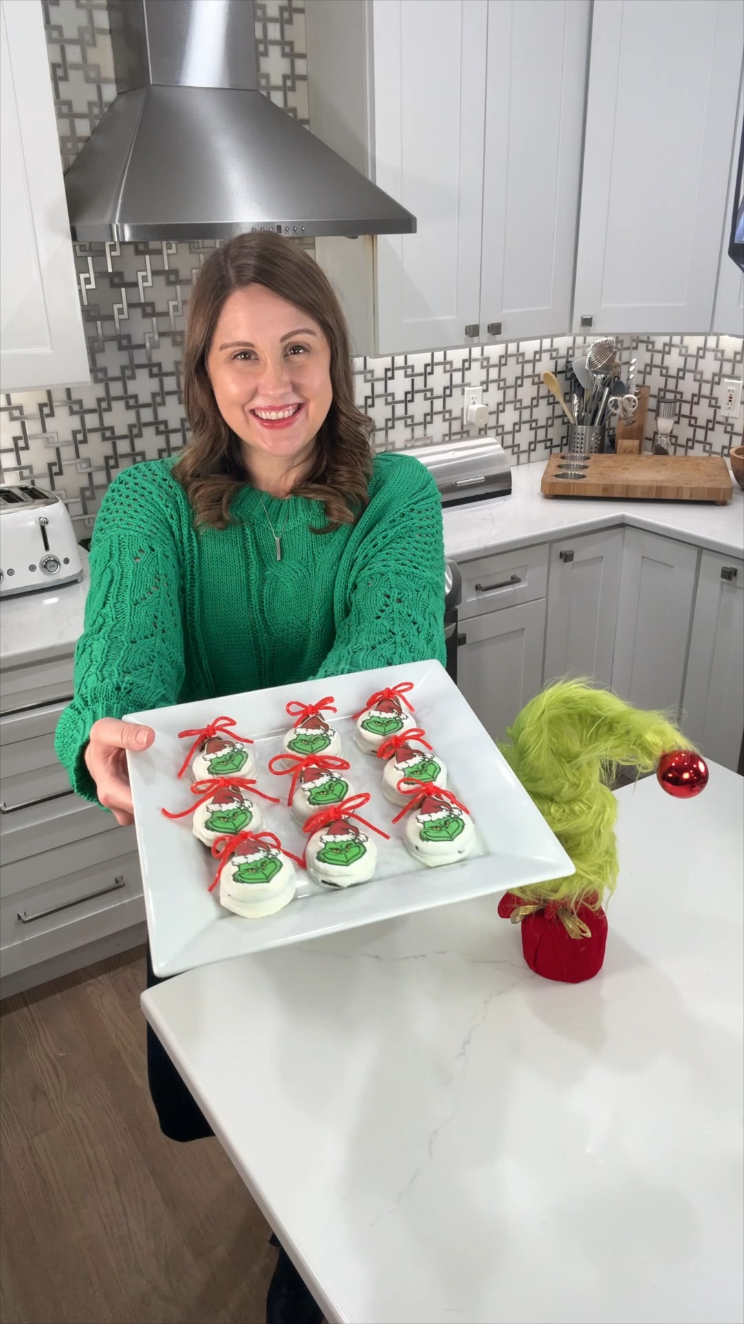 How adorable are these Grinch ornament cookies? Dip holiday Oreos in white chocolate, add an edible Grinch decoration in the center, then top with a mini Reese’s and a cute strawberry licorice bow. These festive treats are almost too cute to eat—perfect for holiday parties or gifting! #HolidayTreats #Grinchmas #DIYOrnamentCookies #ChristmasCookies #Grinch #OrnamentCookies

#LTKHoliday #LTKFamily #LTKSeasonal #LTKHoliday
