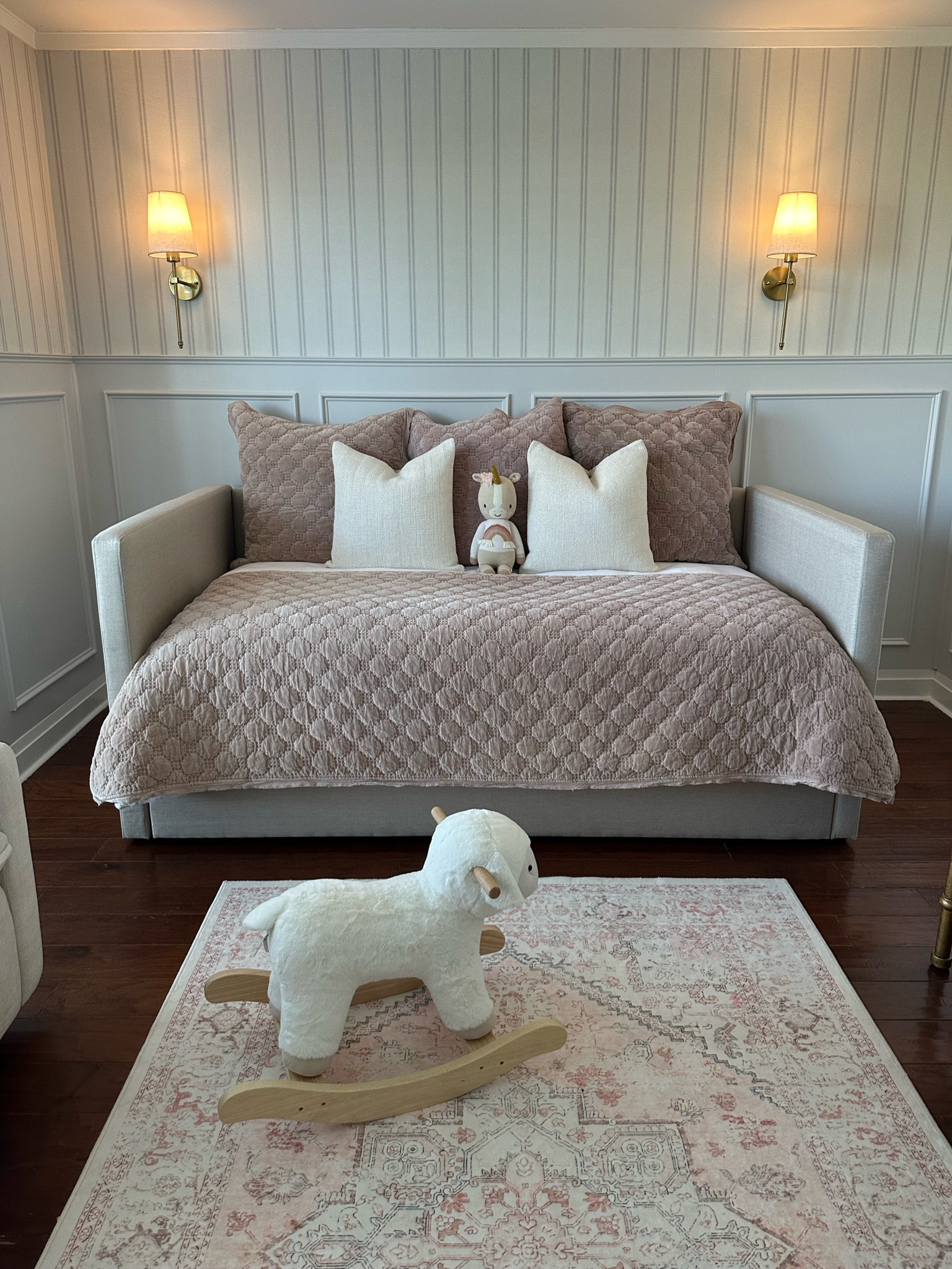 Nursery update!! 

daybed from Living Spaces 
bedding is Pottery Barn (linked)
Lamb rocker is Pottery Barn Kids (linked)
Sconces are Amazon (linked)
Wallpaper is Wayfair (linked)
Rug is Amazon (linked)