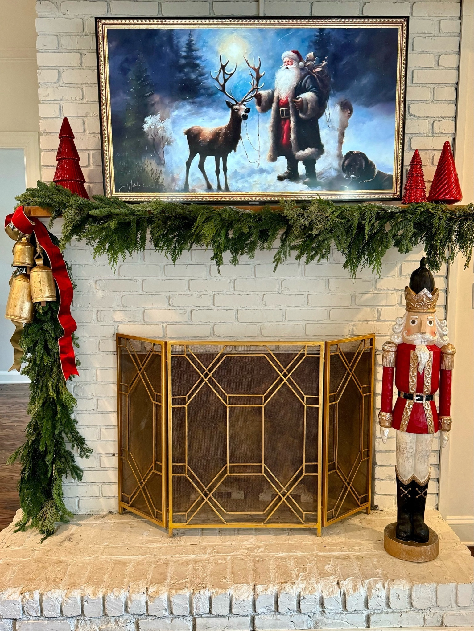 Christmas Mantle with real greenery, velvet ribbon, gold bells, mercury glass trees, nutcrackers 

#LTKHoliday #LTKSeasonal #LTKhome