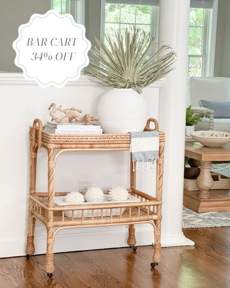My Serena & Lily rattan bar cart is 34% off - the lowest price I've ever seen on it! It's so handy for entertaining, but also makes a great little console table! 
- 
Coastal home, coastal bar cart, serena & Lily bar cart, south seas side cart, dining room decor, rattan bar cart, coastal interiors, coastal style, neutral home decor, summer decor, Amazon dough bowl, bar cart decor, bar cart styling, console table decor, white dough bowl set, real white seashell sphere, shelf decor, beach house decor, driftwood beach, palm stems, neutral vase, large white vase, Amazon coffee table books, coastal coffee table books, Florida home decor, decorating ideas, summer entertaining, rattan console table, beach house decor, beach house furniture, memorial day sales, home sale

#LTKSaleAlert #LTKStyleTip #LTKHome