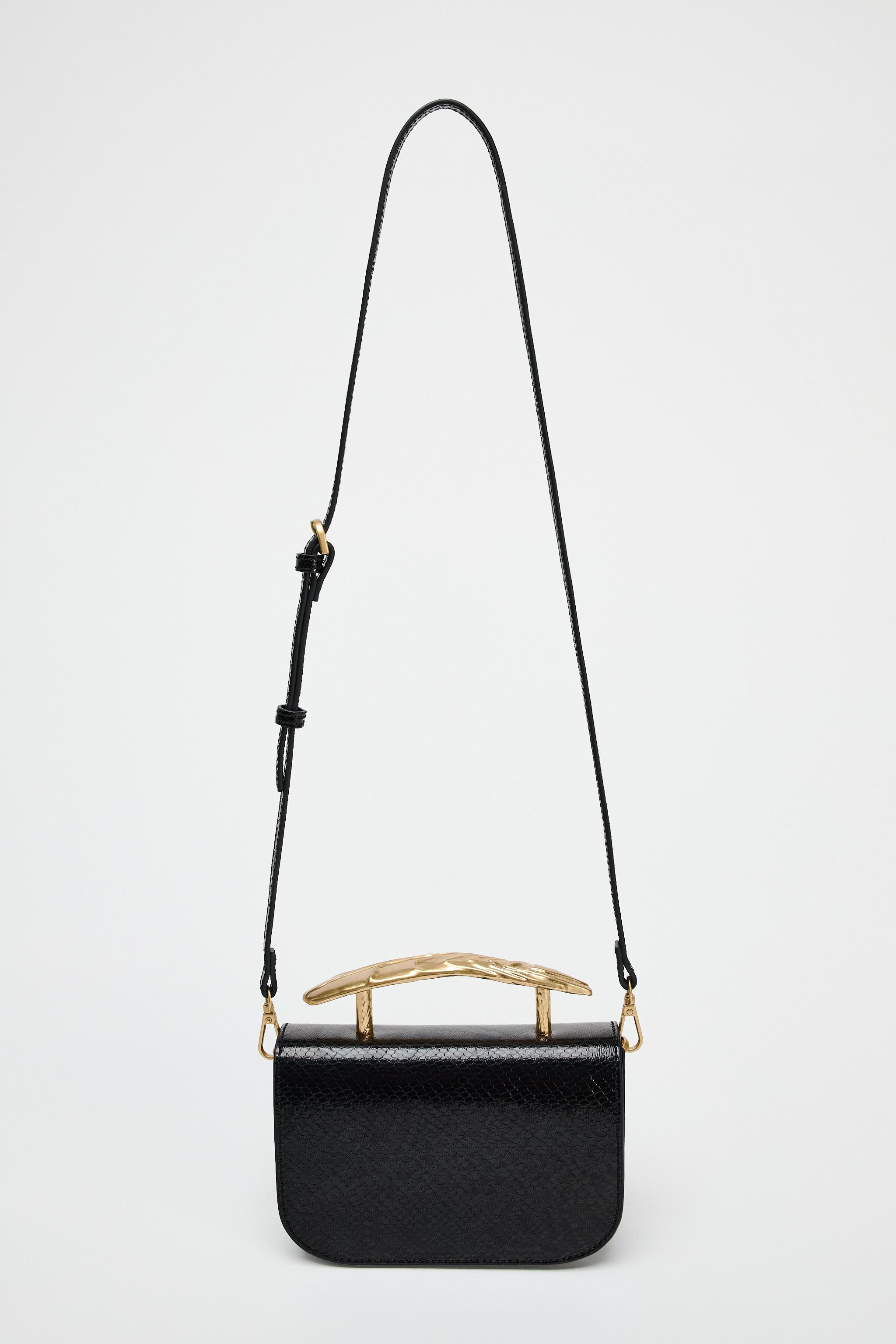 Mini bag with embossed exterior. Gold metallic top handle and adjustable crossbody strap. Interio... | Zara US