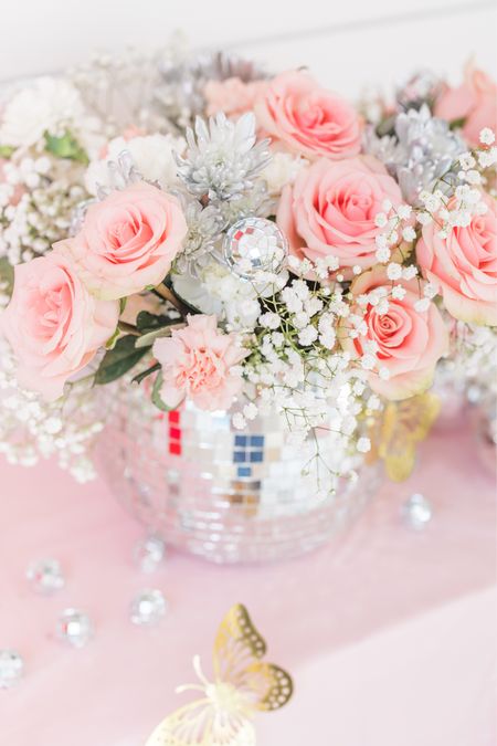 I found these mirrorball / disco ball vases at TJ Maxx and filled them with grocery store Flowers’s to pull in some sparkle I broke apart these disco ball tree picks and added them into the florals 

#LTKHoliday #LTKparties #LTKkids