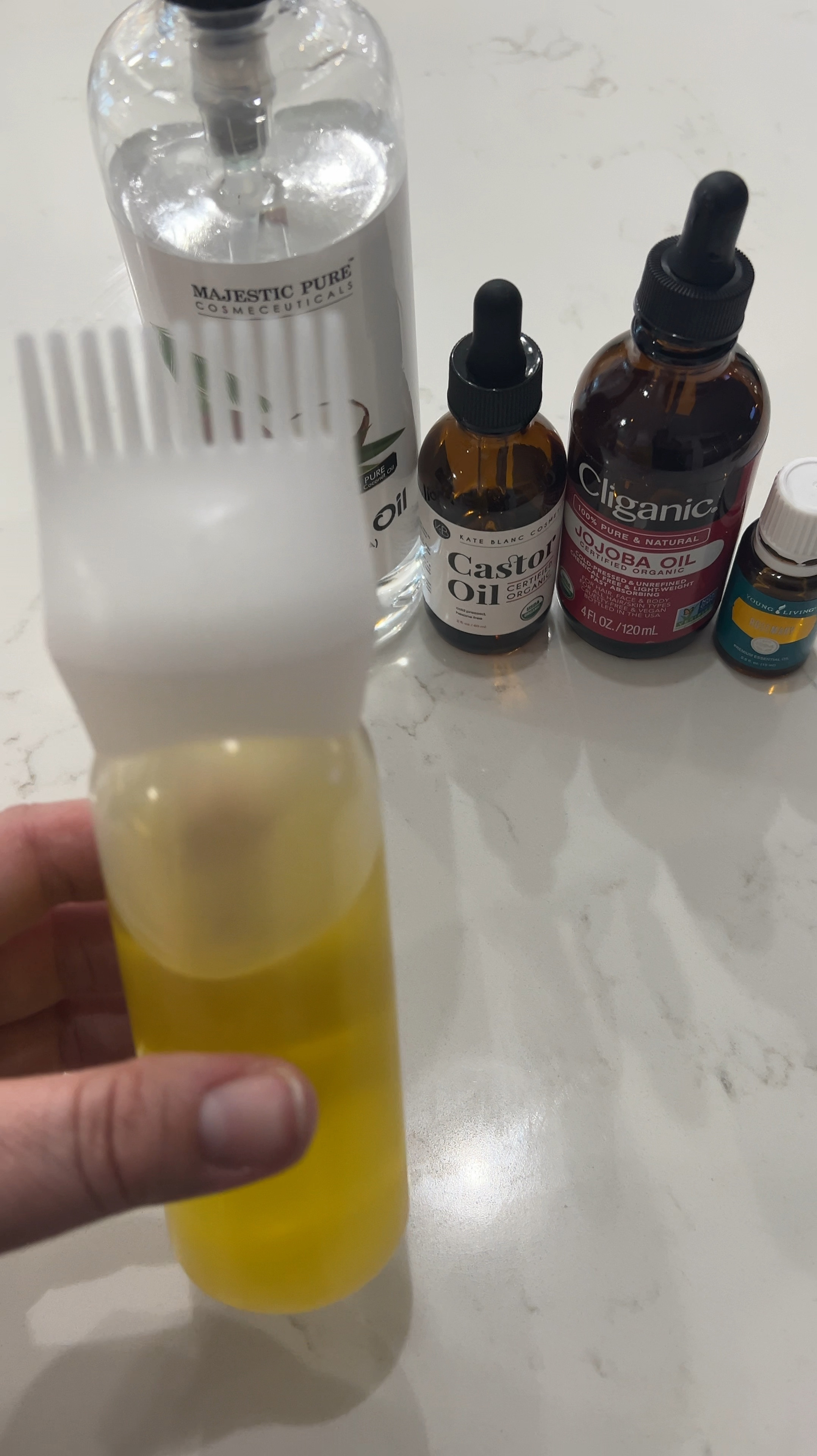 This is my hair oil recipe - 2 ounces fractionated coconut oil, 2 ounces jojoba oil, 2 ounces castor oil, and 25 drops of rosemary essential oil. Then I comb it through my hair with this oil combing bottle and leave it on anywhere between 2 hours to overnight. 

#LTKOver40 #LTKVideo #LTKBeauty