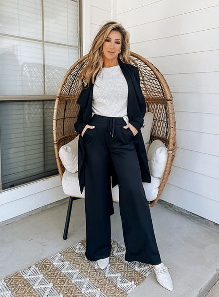 GibsonLook elevated casual weekend look, business casual outfit, black drawstring wide leg knit pants, slouchy off white sweater, off white mules, black belted shawl collar coat jacket cardigan 

#LTKworkwear #LTKover40 #LTKstyletip