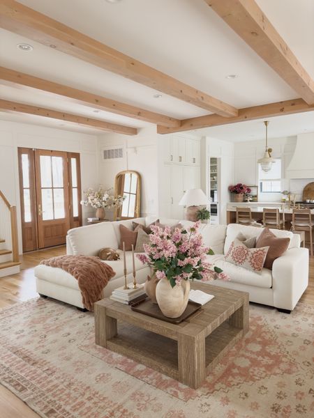 Spring living room reveal with pops of pink, warm whites, and natural wood tones! This sectional has been a huge hit separating our living space from our kitchen 

Spring refresh, living room reveal, creamy whites, pops of pink, spring living room style, Pottery Barn style, light and bright, aesthetic home, spring home inspo, my design style, neutral area rug, faux florals, vase details, throw pillow, coffee table, furniture favorites, sectional style, lamp faves, throw blanket, gold tray, home aesthetic, neutral home, faux lilac stems, spring pillow, shop the look!

#LTKstyletip #LTKhome #LTKSeasonal