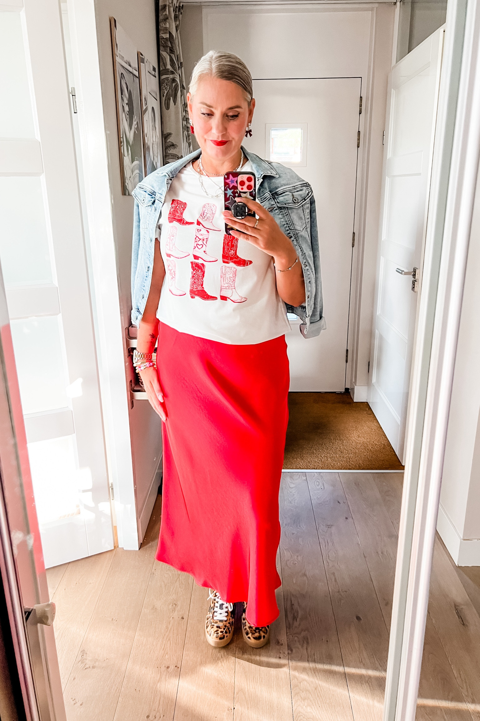 Ootd - Wednesday. Red satin skirt (Neo Noir via Molly & My), t-shirt with western boot or cowboy boot print, denim jacket, smiley necklace, pearl necklace, suede leopard sneakers and crew socks. 
Red and pearl bow earrings  


#LTKnederlands #LTKeurope #LTKsummer