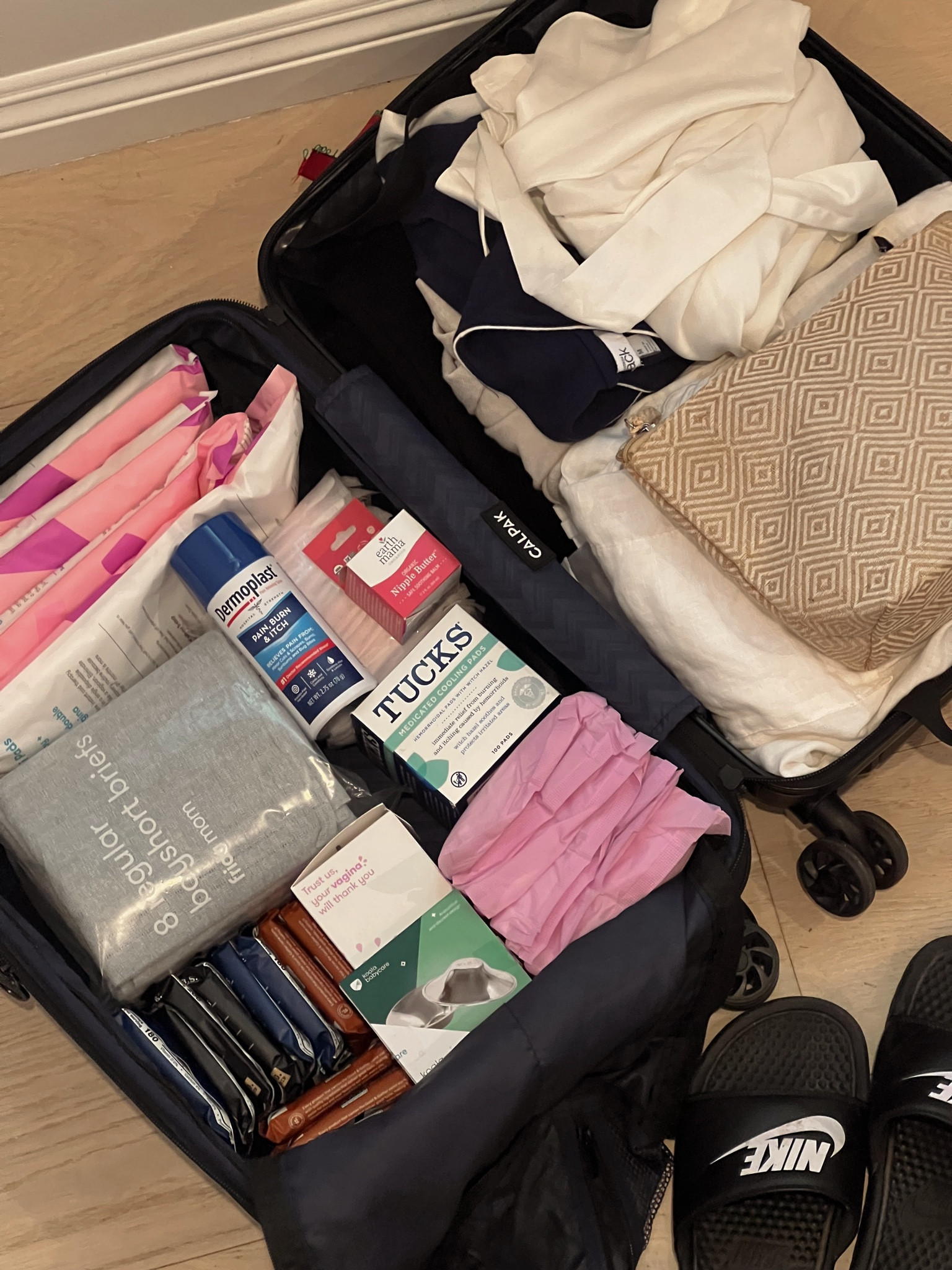 What I packed in my hospital bag for postpartum 

Calpak carry on luggage - black 
Frida mom disposable boy shorts
Frida mom postpartum pads 
Frida mom peri bottle 
Frida mom ice pads 
Dermoplast Hospital grade pain relieving spray - make sure you get this! 
Tucks witch hazel pads - this accelerates healing - a must! 
Stay dry nursing pads 
Momcozy s12 pro wearable breast pump 
Organic nipple butter 
Nursing silver cups for breastfeeding 
- 100% silver 999
Nursing bras - have been super comfortable during pregnancy 
Clean protein bars  (I got some with dates to help with labor) 
Old sandals (Nikes) 
Comfortable dark pajamas 
Comfortable robe 
Dark towel 
Makeup bag 
Loose dress to leave hospital 

Postpartum 
Maternity 
Bump 

#LTKFindsUnder100 #LTKBaby #LTKBump