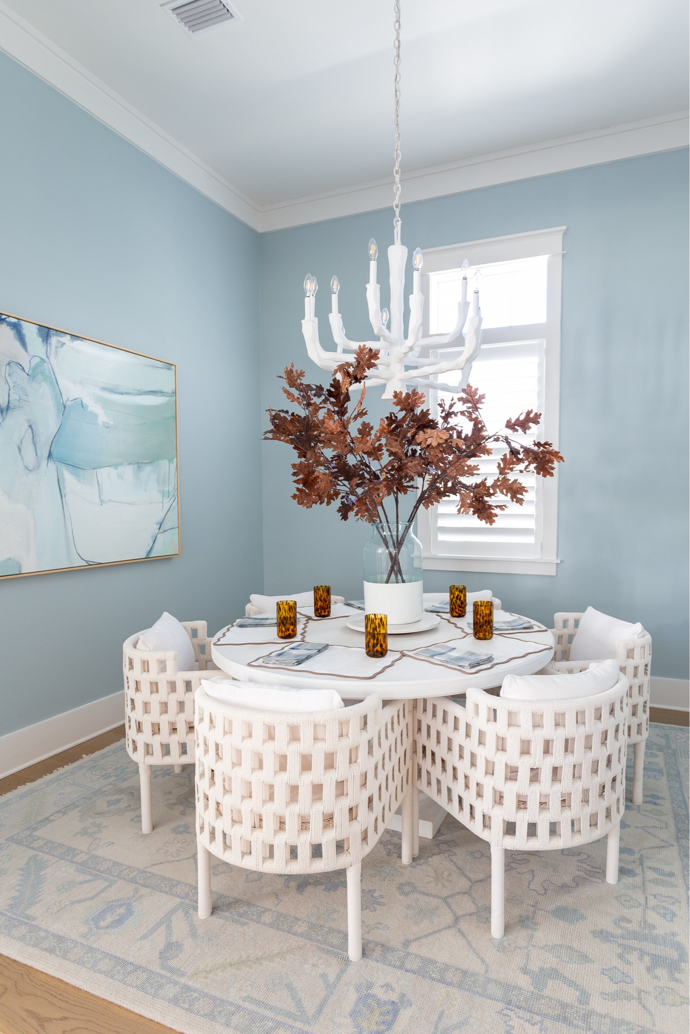 Our coastal blue dining room decorated for fall with brown accents! Includes my favorite faux brown oak leaves, white rope dining chairs, white concrete dining table, blue abstract art, tortoise drinking glasses, scalloped placemats, plaid napkins and marble lazy susan! #ltkhome #ltkseasonal #ltksalealert #ltkstyletip #ltkfindsunder50 #ltkfindsunder100

#LTKSaleAlert #LTKHome #LTKSeasonal