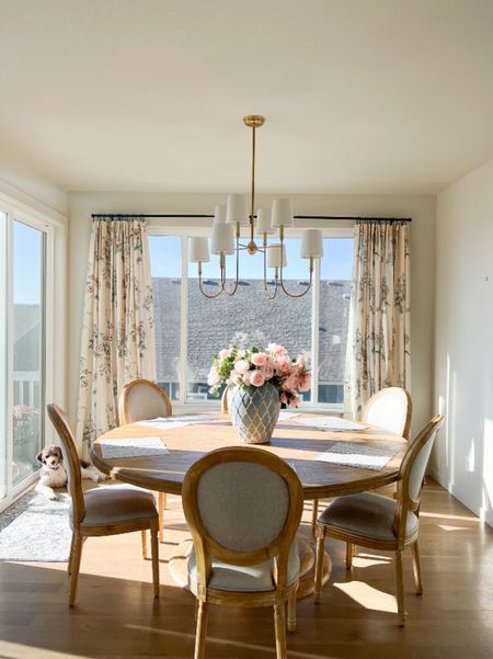 Round pedestal dining room table, light wood, French country dining room upholstered chairs, Vendome Visual Comfort brass chandelier, floral curtains.

#LTKxPrime 

#LTKhome