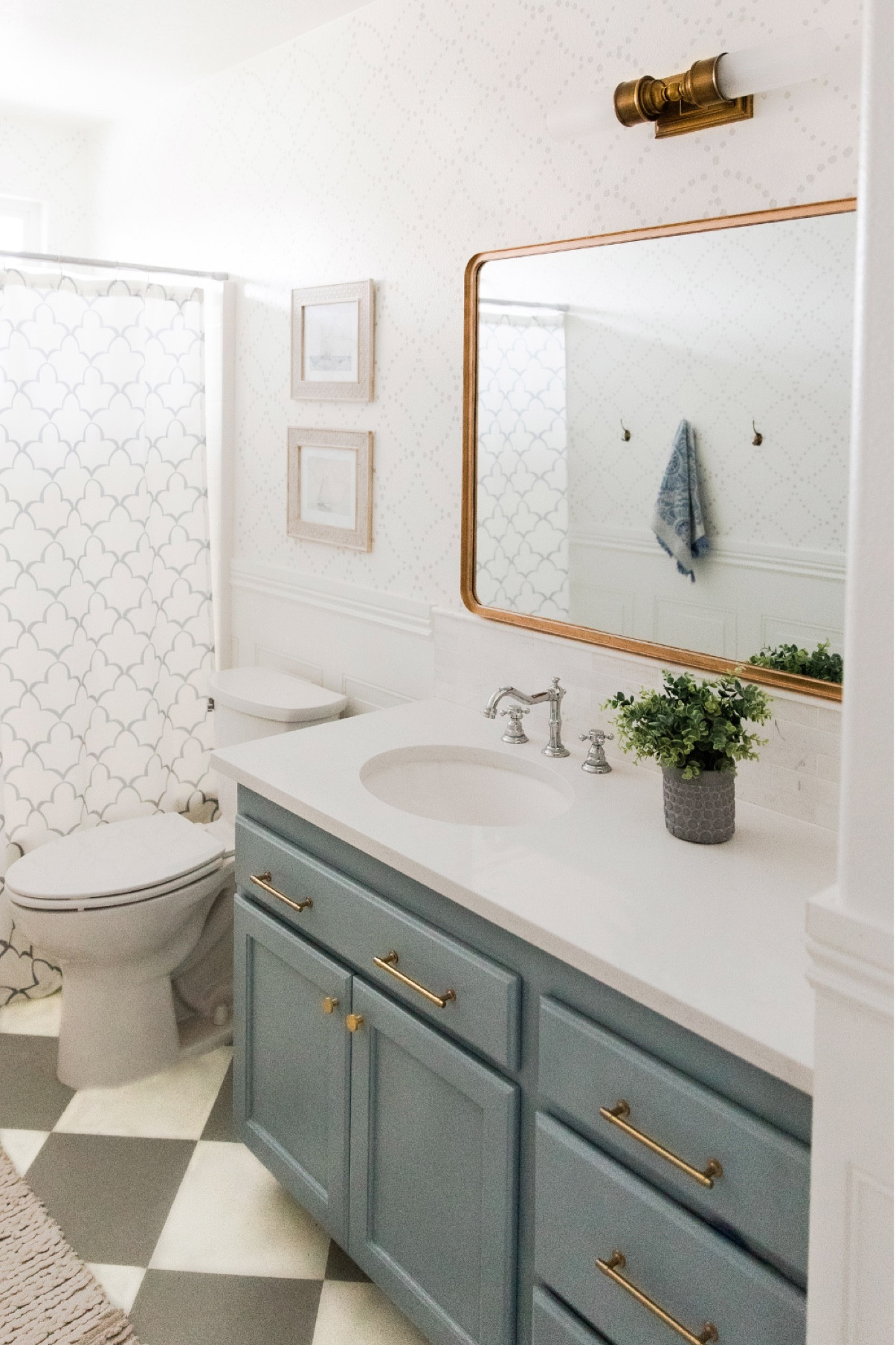 Blue vintage bathroom // kids bathroom ideas // guest bathroom ideas // shower curtain // pottery barn bathroom wall sconce // chrome heritage faucet // brass hardware

#LTKhome