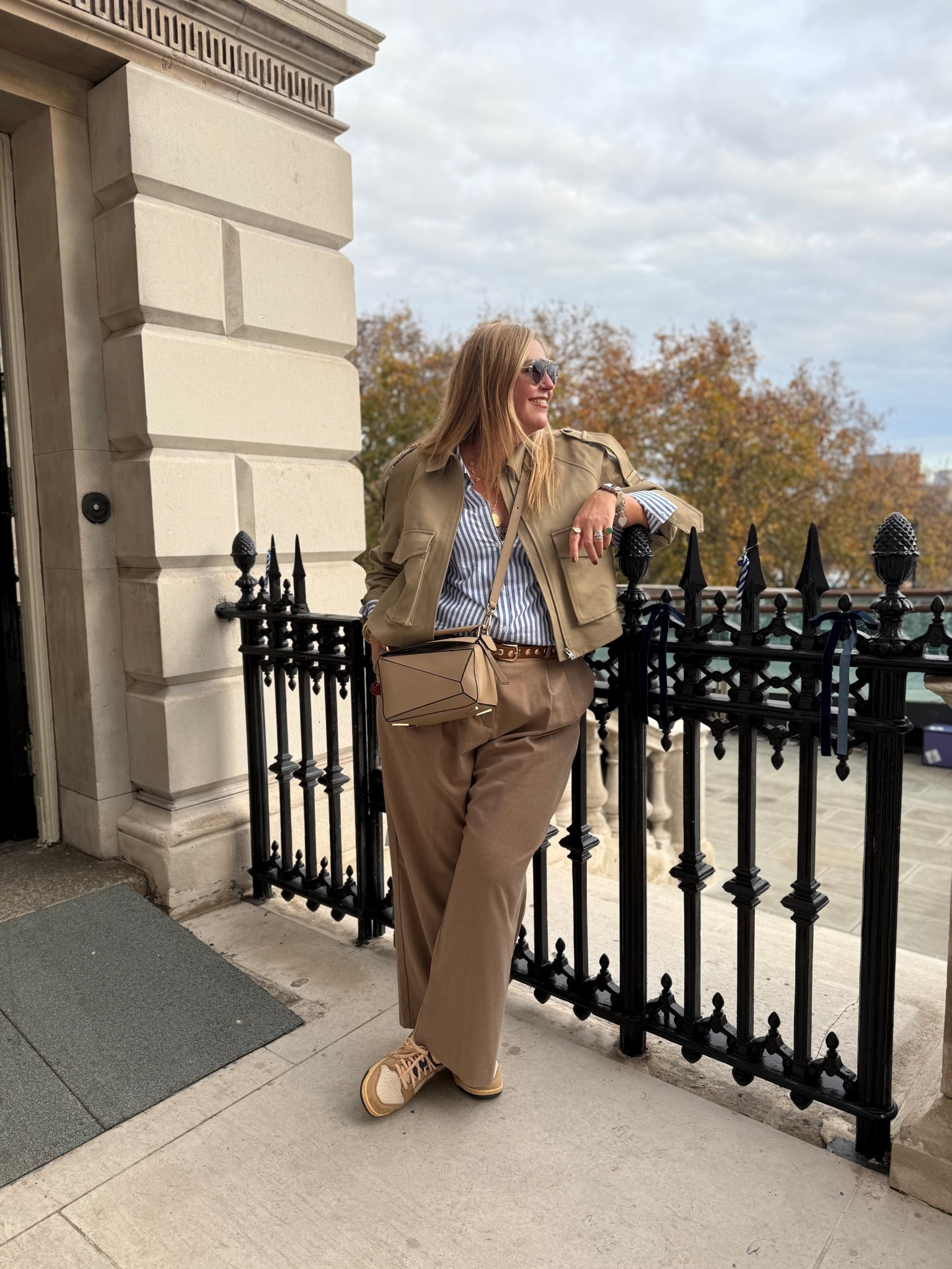Beige cropped trench, beige trousers, blue striped shirt, tan trainers, beige bag, sunglasses 

#LTKautumn #LTKcurves #LTKplussize