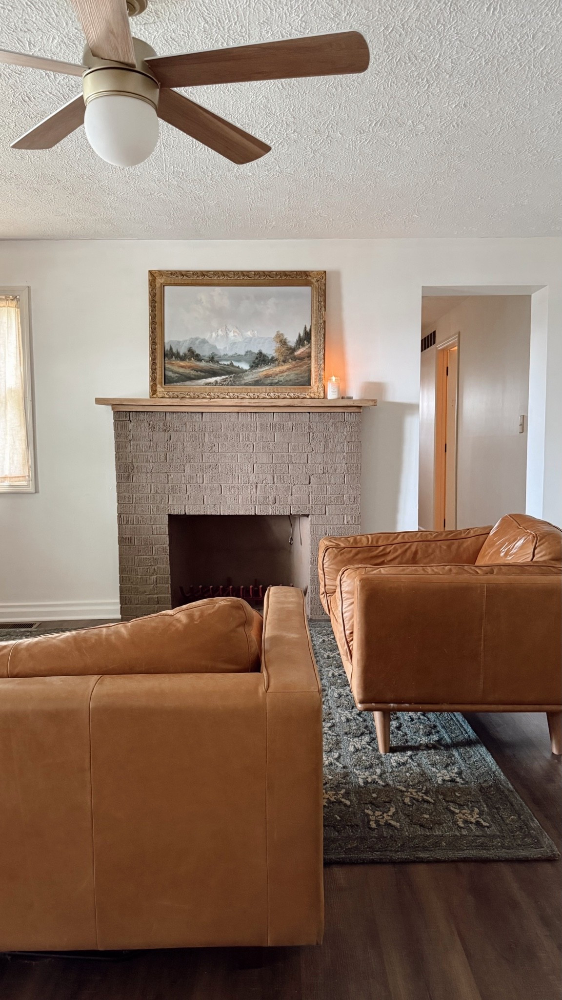 Scroll over…Comment “stain” or “shop” for the gel stain I used on the mantle (after the paint) and for this beautiful rug and ceiling light/fan. My daughter has this fireplace that no longer works bc of chimney issues and they wanted to get rid of these vent holes without loosing the brick character…I love how it turned out, and so do they🙌 This amazing hand tufted wool rug from @heidicaillierdesign and @joonloloi fits perfectly in here 😍