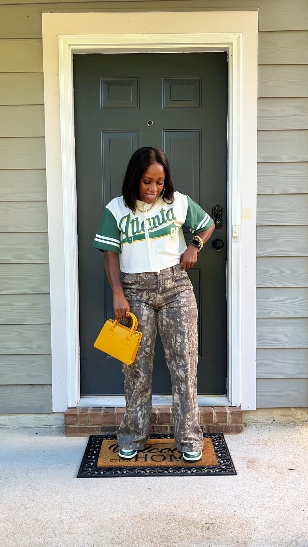 How to style camo cargo pants with a cropped baseball shirt. I accessorize this casual outfit with a gold chain necklace, yellow purse, and vintage green Nike dunk low sneakers

#LTKPetite #LTKFindsUnder100 #LTKStyleTip