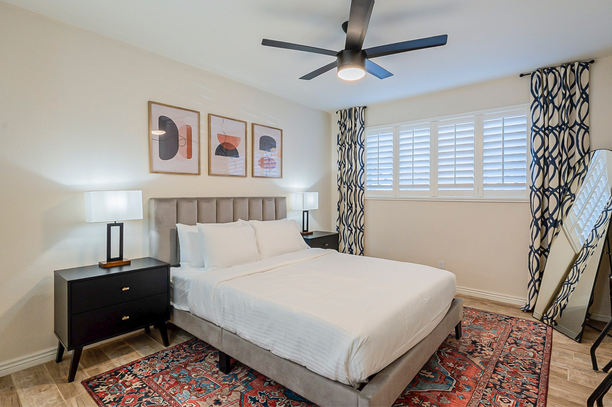Airbnb bedroom - boho pops of color in medallion rug. Art from Etsy 

#roomstyling #airbnbdecor #bohorug #blacknightstands #greyvelvetbed 
