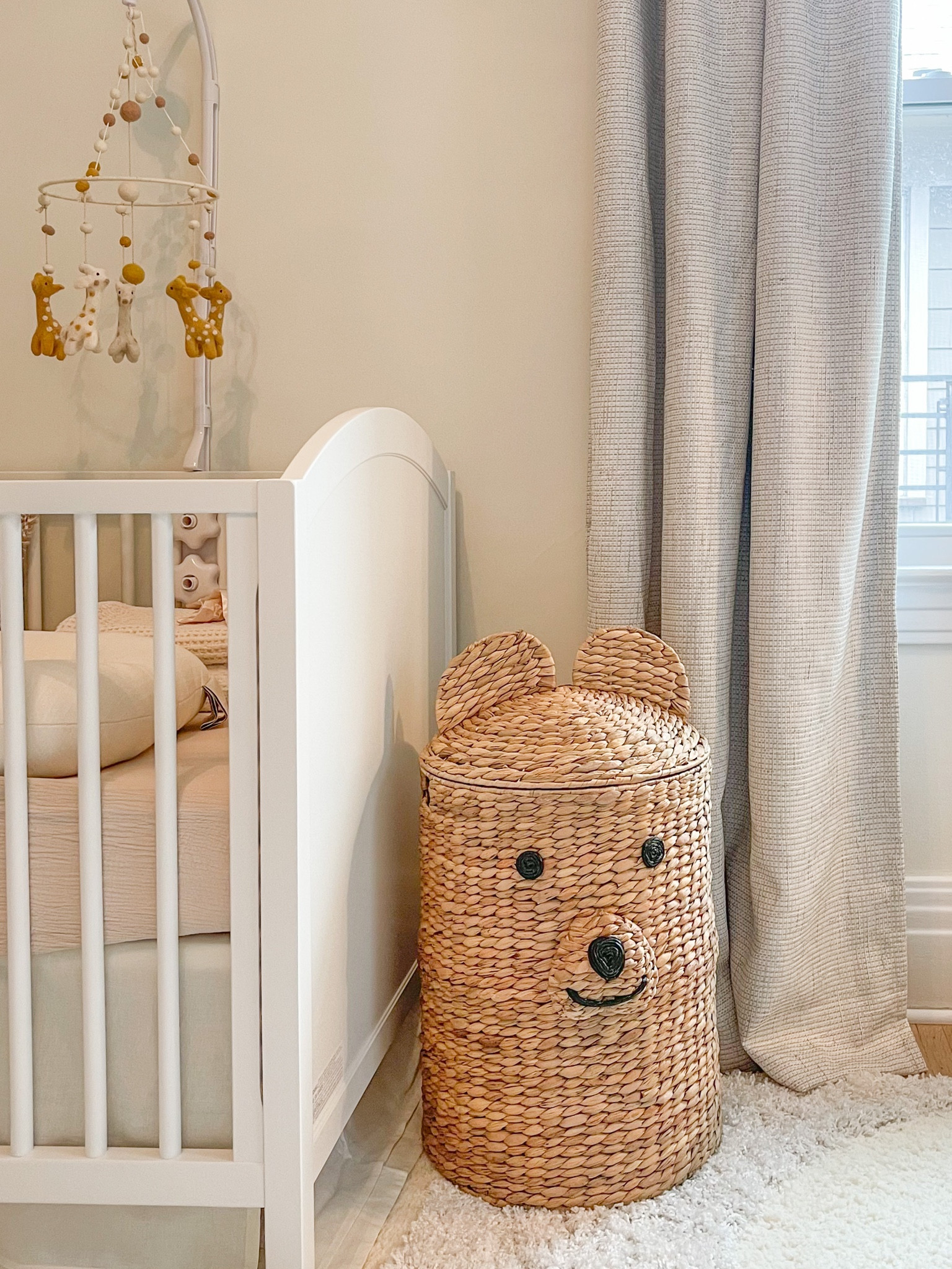 The cutest bear hamper from crate and barrel! Love how it adds a playful touch to our gender neutral, minimal nursery design. 
Crib is pottery barn
Window curtains are Amazon 
Rug is rugsusa