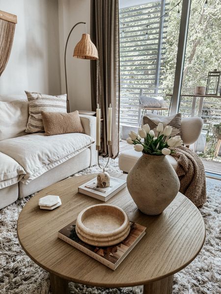 Coffee table styling in my living room 

Vase, bowl, candle holder, lamp, pillows, white sofa, accent chair 

#LTKhome