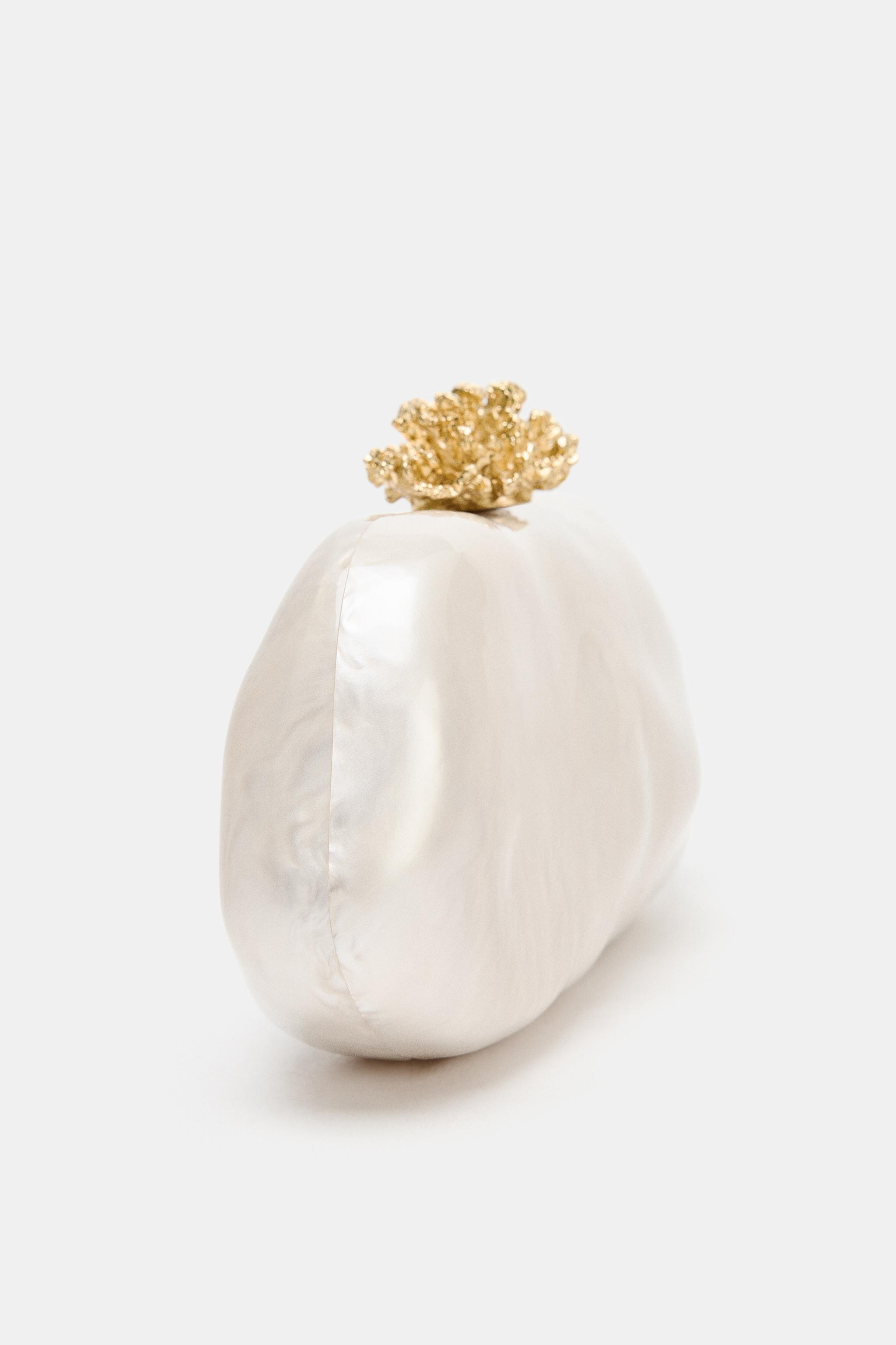 Clutch bag. Pearlescent effect top. Clasp closure with metal detail. Metal chain strap to wear ac... | Zara UK