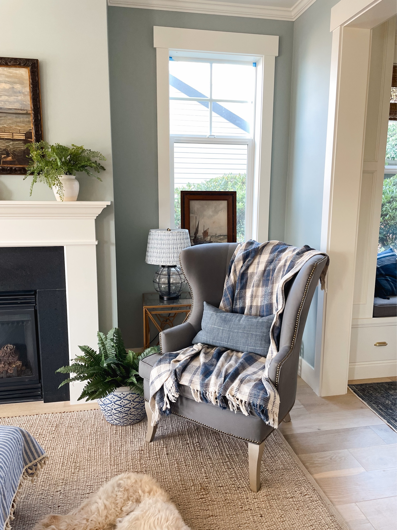Gray wingback arm chair, navy plaid throw, jute/cotton area rug, pleated patterned shade, blue and white pleated lampshade, faux fern

#LTKhome #LTKSeasonal #LTKsalealert