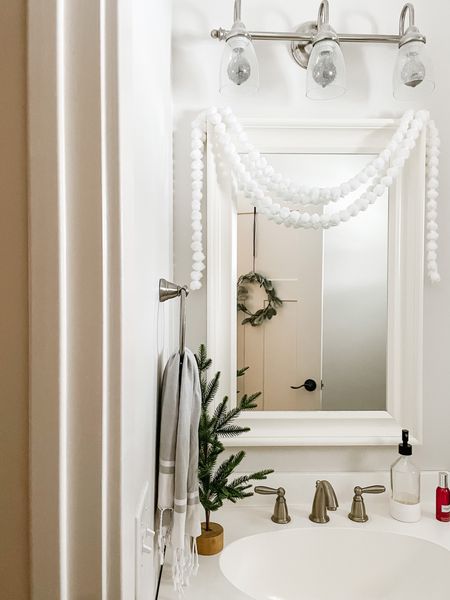 A sprinkle of holiday decor in the bathroom space. ✨

#vanity
#vanitymirror
#holidaydecor
#bathroomstyling

White pom garland, mini tree, bathroom mirror, bathroom towels, vanity styling, holiday home decor

#LTKSeasonal #LTKHoliday #LTKhome
