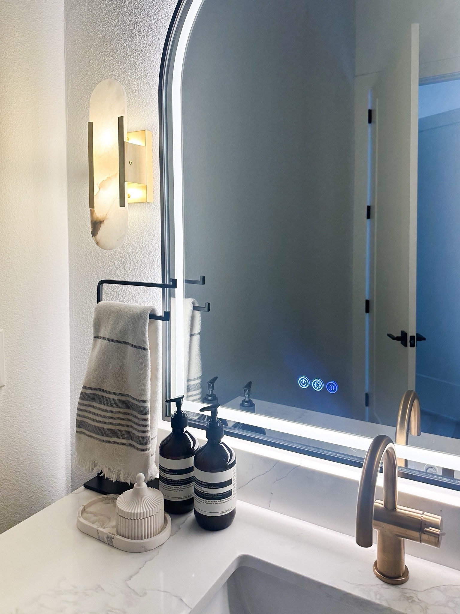 Bathroom styling with led light mirror, brass hardware, hand towel rack, sconces and more 

#LTKHome #LTKStyleTip