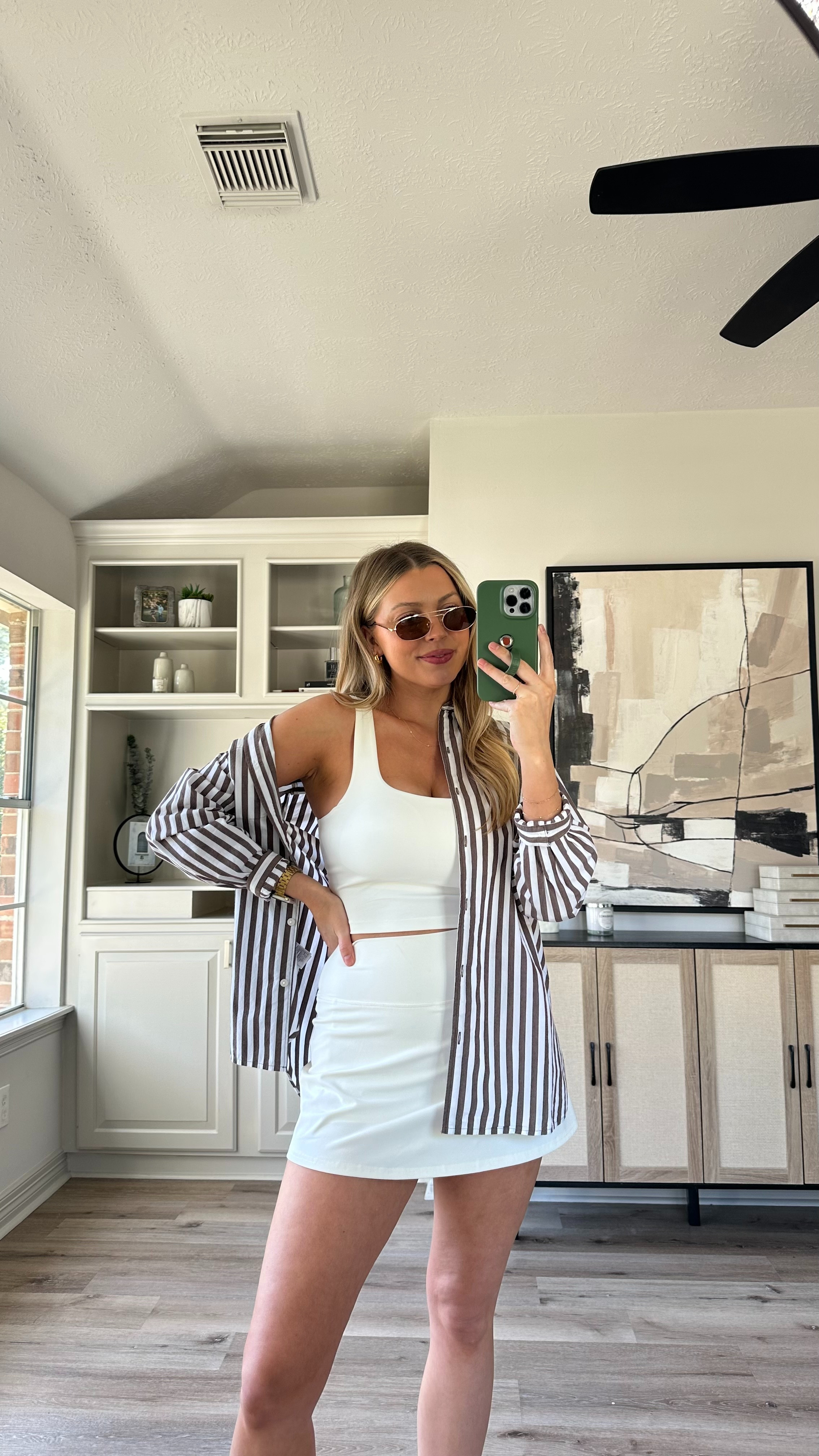 Casual Spring Outfit | This athletic skort is my favorite! It feels so similar to another brand. Wearing size M in the skort, white top, and striped button up. Sandals fit tts. 

 

#LTKActive #LTKStyleTip