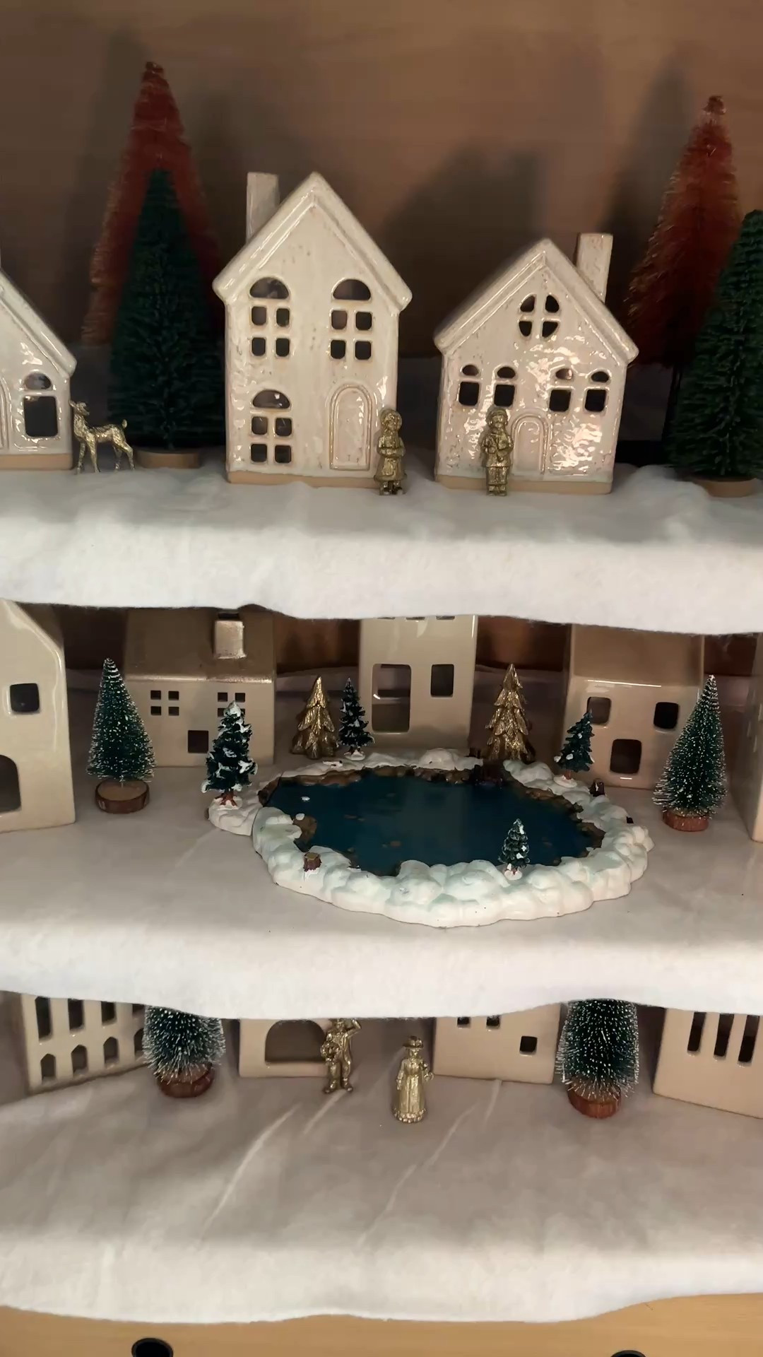 Arched cabinet Christmas village! 

White ceramic houses, gingerbread houses, bottle brush trees, brass figurines, garland , faux snow blanket, lemax Christmas village skaters

#LTKHoliday #LTKHome #LTKSeasonal