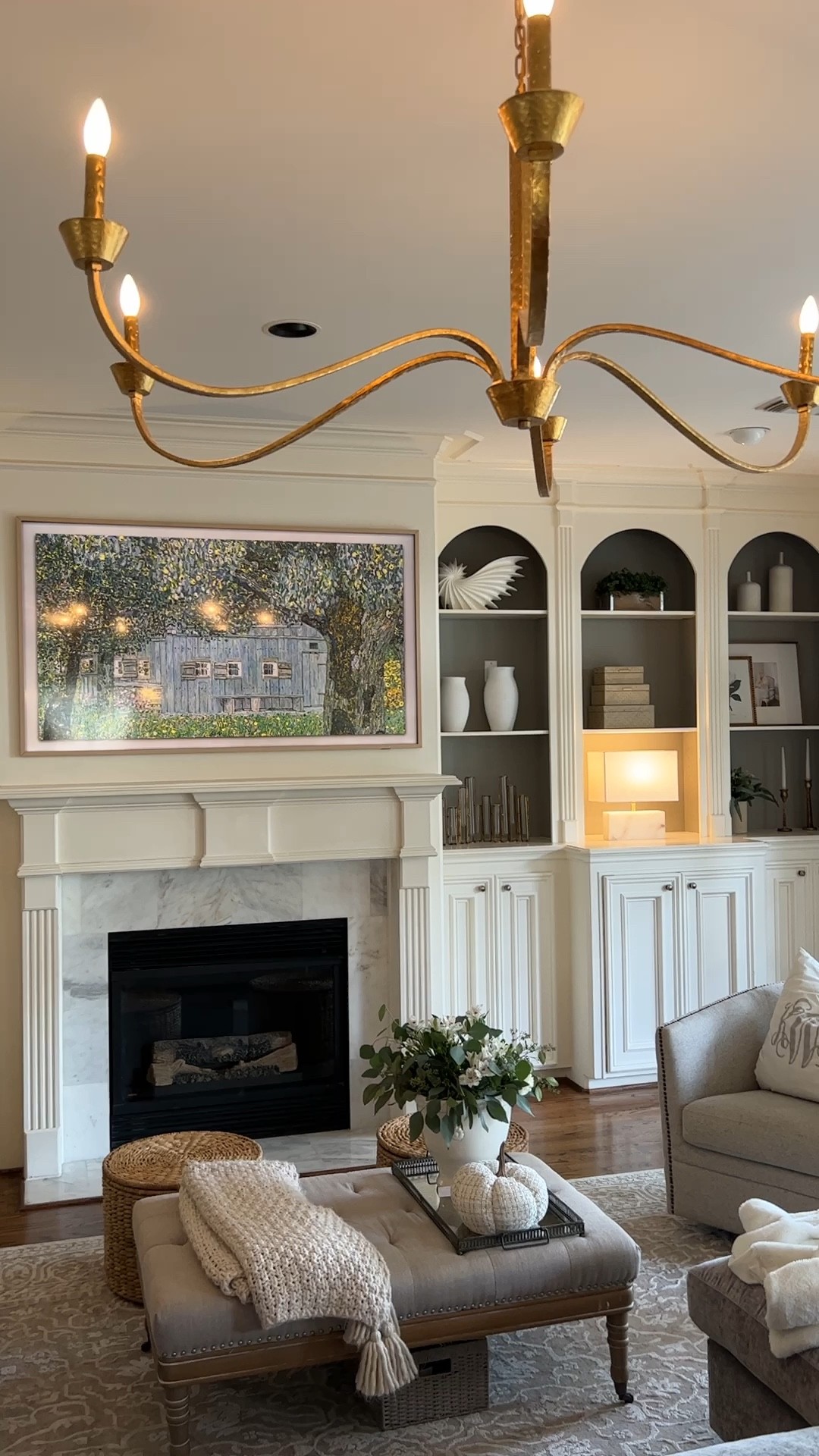 Living room Samsung frame TV teak frame modern teak family room round ottoman storage toy storage kid friendly large gold chandelier￼

#LTKsalealert #LTKstyletip #LTKhome