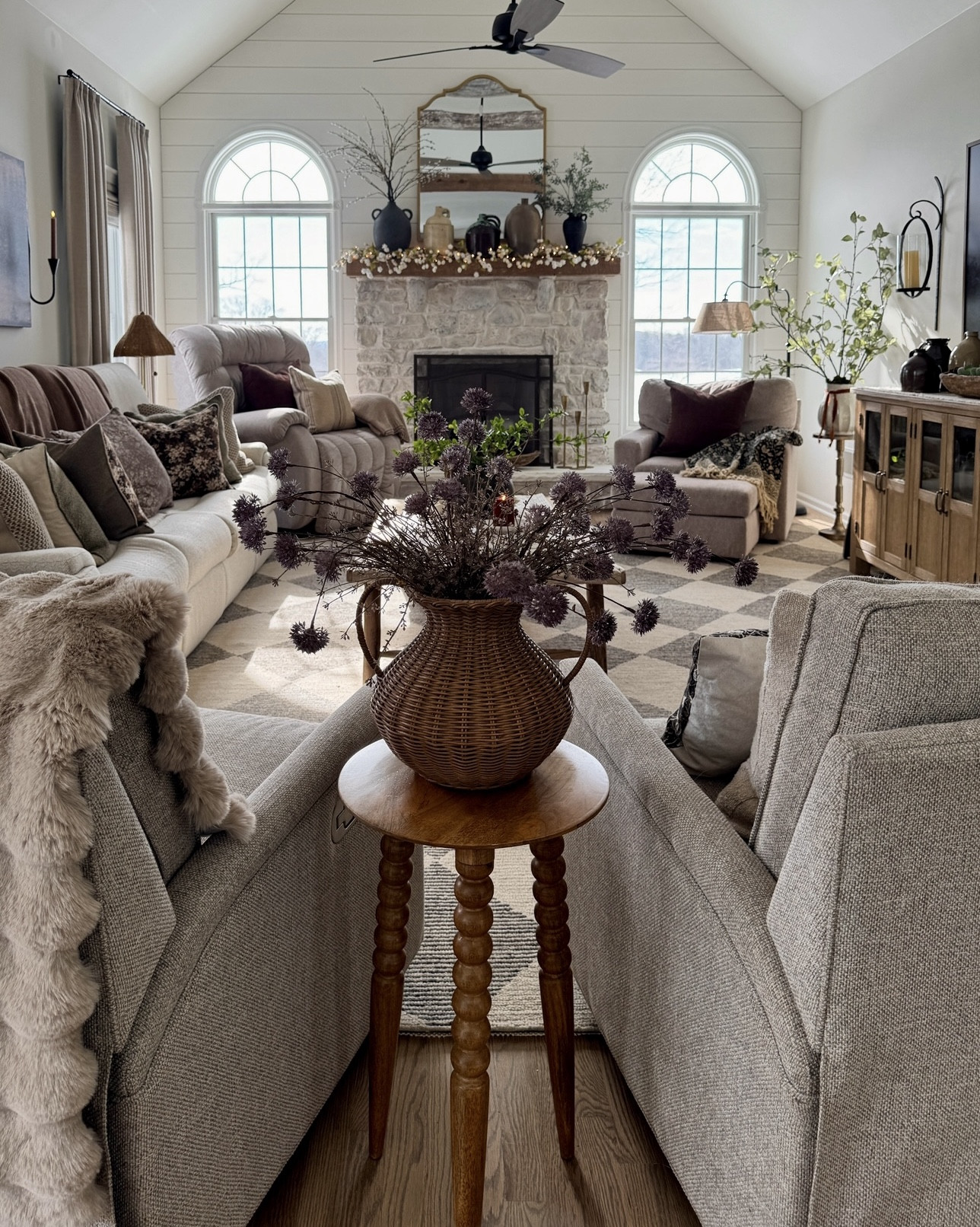 Family room styling:

Faux florals and stems
Accent tables
Area rug
Fireplace mirror
Floral throw
Candlesticks
Battery operated candles 
Coffee table books
Solid wood buffet table
Electric fireplace insert 
Throw pillows 
Rocker gilder accent chairs 
Vases
Woven accents