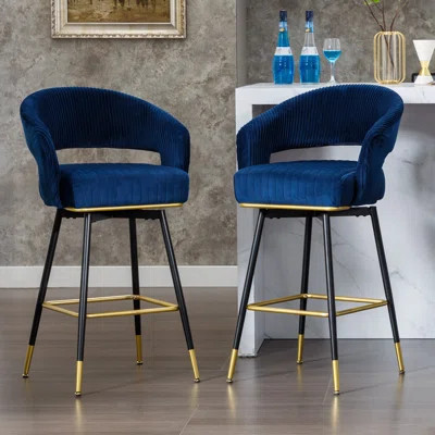 Sapphire blue velvet swivel bar stools with curved backs and gold accents