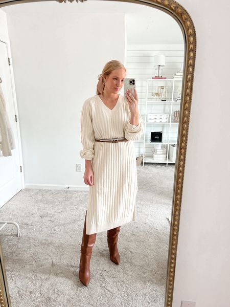 Chic fall outfit in a cozy sweater dress (small) under $50 with knee high boots (run big). I layered two belts to bring in my waist, but it looks great without the belt too! 