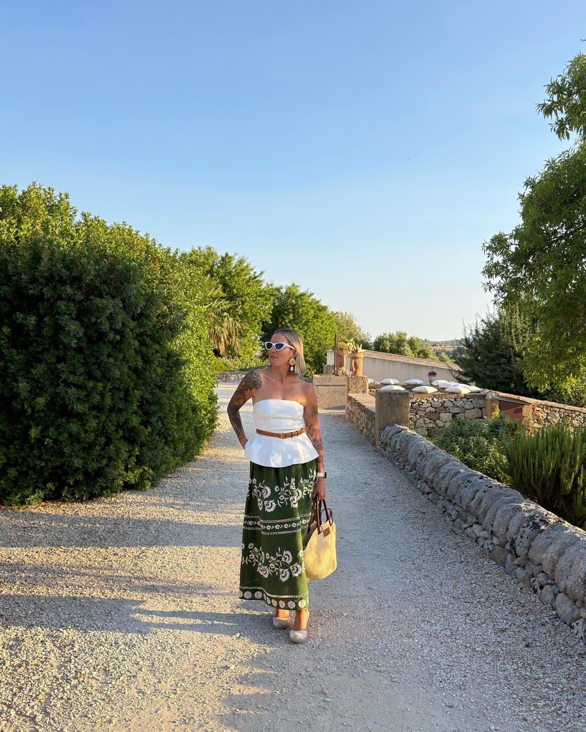 An easy European summer outfit 🤍 A strapless white peplum top paired with a printed green maxi skirt, woven tote, sandals, and statement sunglasses. Perfect for sightseeing, long lunches, and golden-hour dinners. ☀️🇮🇹

#LTKootd #LTKPetite #LTKTravel