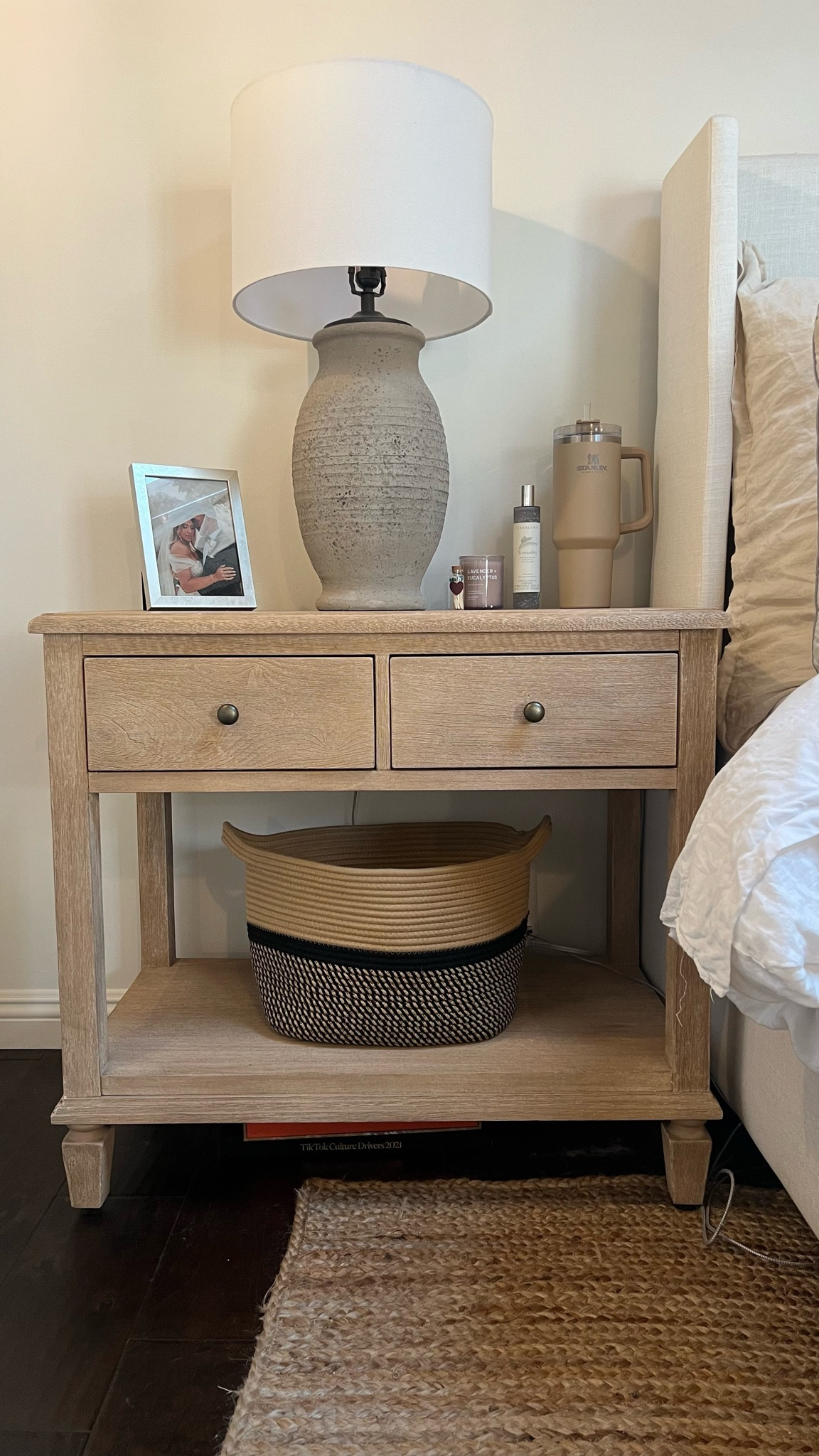 Linked my nightstand and all of the essentials on it for you. Do you think my husbands side looks just as organized😂 #potterybarn #nightstand #nightstanddecor #amazondecor #weddingphoto #essentialoils #targethome #potterybarnlamp #candles #juterug #stanleytumbler 

#LTKFind #LTKstyletip #LTKhome