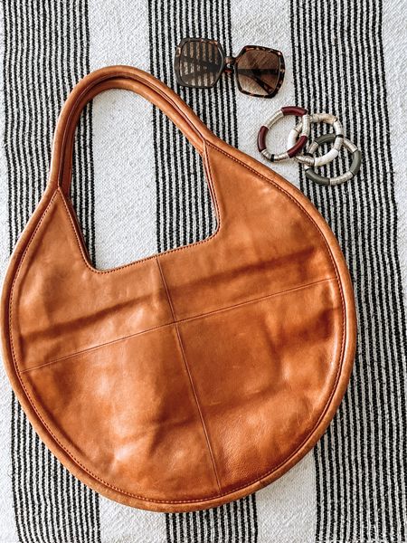 One of my favorite fall tote bags 🧡I love how the circle shape is unexpected. Real leather at a reasonable price point, holds a lot! 

#LTKstyletip #LTKitbag #LTKSeasonal
