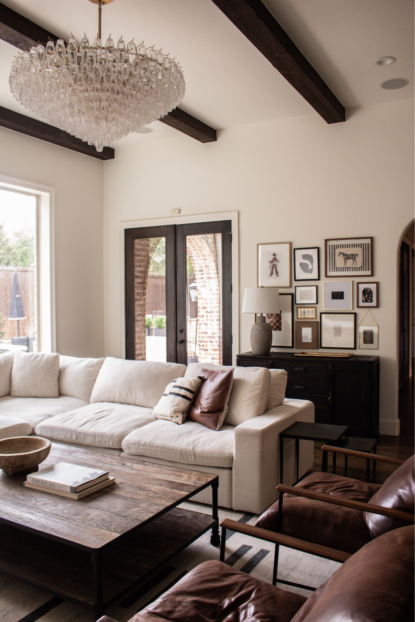High ceilings + exposed beams = instant character. Open living room, statement chandelier, natural light, minimalist home decor, inviting family space.

#LTKSeasonal #LTKHome