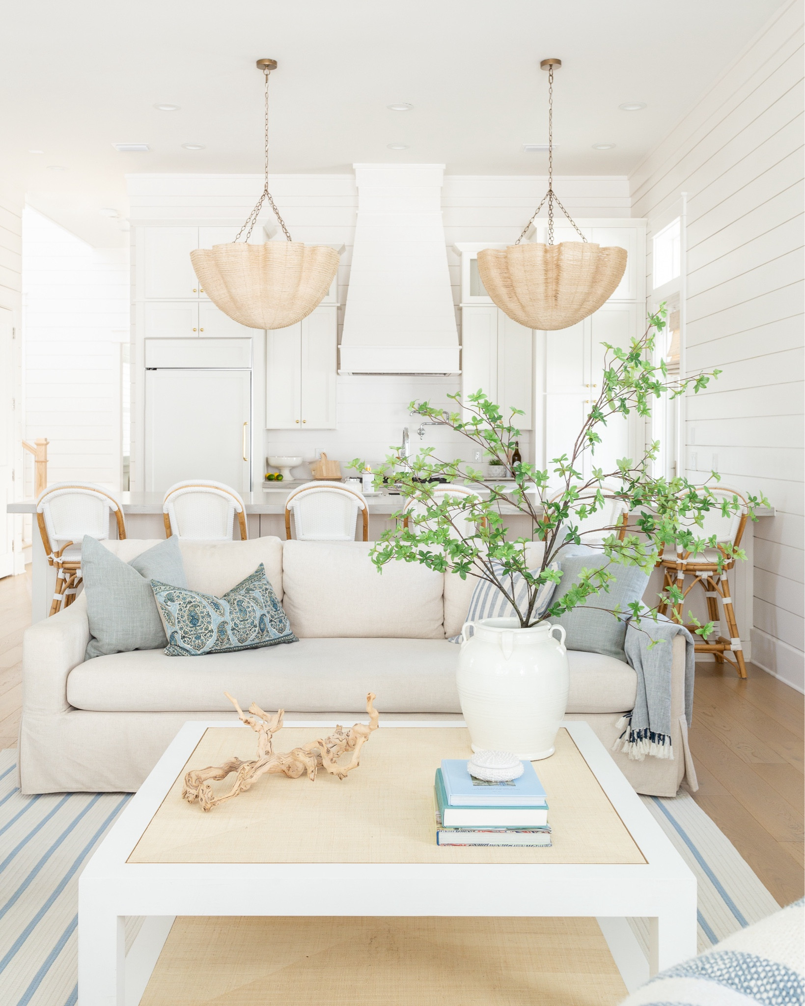 Our living room and kitchen decorated for spring! Includes our favorite linen sofas, a blue and white striped rug, raffia coffee table, frame tv art for spring, a large greenery branch, blue linen pillows, paisley lumbar pillow, striped pillows, woven Roman shades, scalloped chandeliers, swivel counter stools, and more! See the full spring tour here: https://lifeonvirginiastreet.com/2024-spring-home-tour/.
.
#ltkhome #ltksalealert #ltkseasonal #ltkfindsunder50 #ltkfindsunder100 #ltkstyletip spring decor, spring living room, coastal decor, 

#LTKSeasonal #LTKsalealert #LTKhome