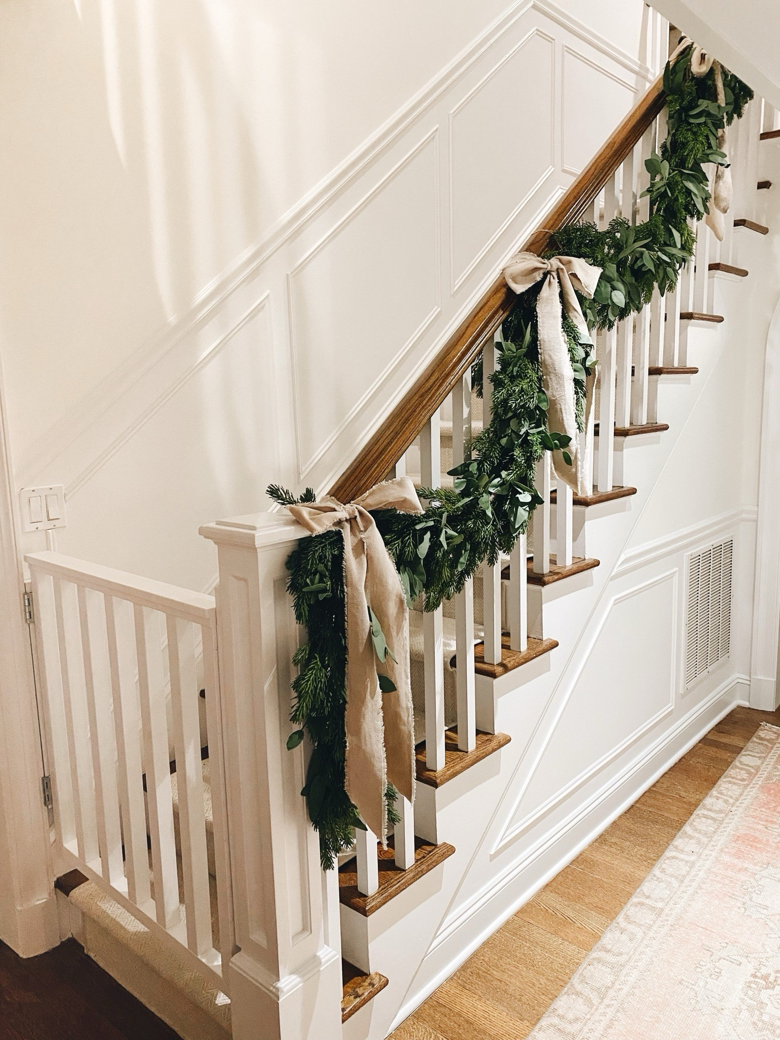 Christmas garland + ribbon details:
I double layered the garland and used 6 total for my stairs. (Mine is a few years old & no longer available, but it’s faux pine garland ) 
Then added in the eucalyptus and intertwined it, used 3 in total (ordered two 2-packs)
1 roll of Ribbon in the large size (64mm) in the cream color shown (tons of colors)
#holidaydecor #garland #fauxgarland #christmasdecor

#LTKhome #LTKunder100 

#LTKHoliday #LTKHome