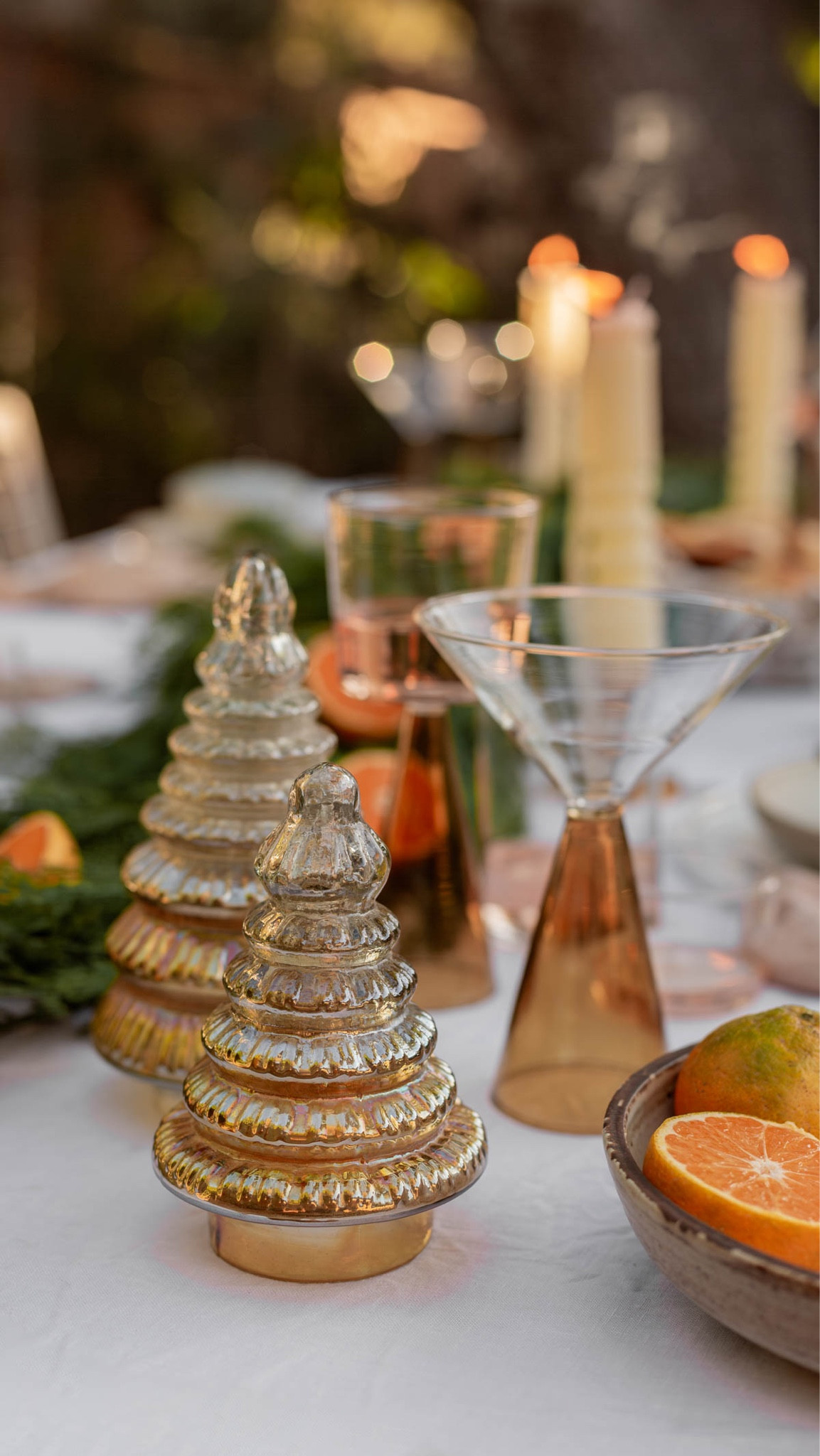 Holiday vibes. I set the outside dining table with a Christmas tablescape vibe and I love the color combo. Lots of that amber / rust orange in the mercury glass Christmas trees and the colorblocked glassware. Holiday entertaining 

#LTKSeasonal #LTKparties #LTKHoliday