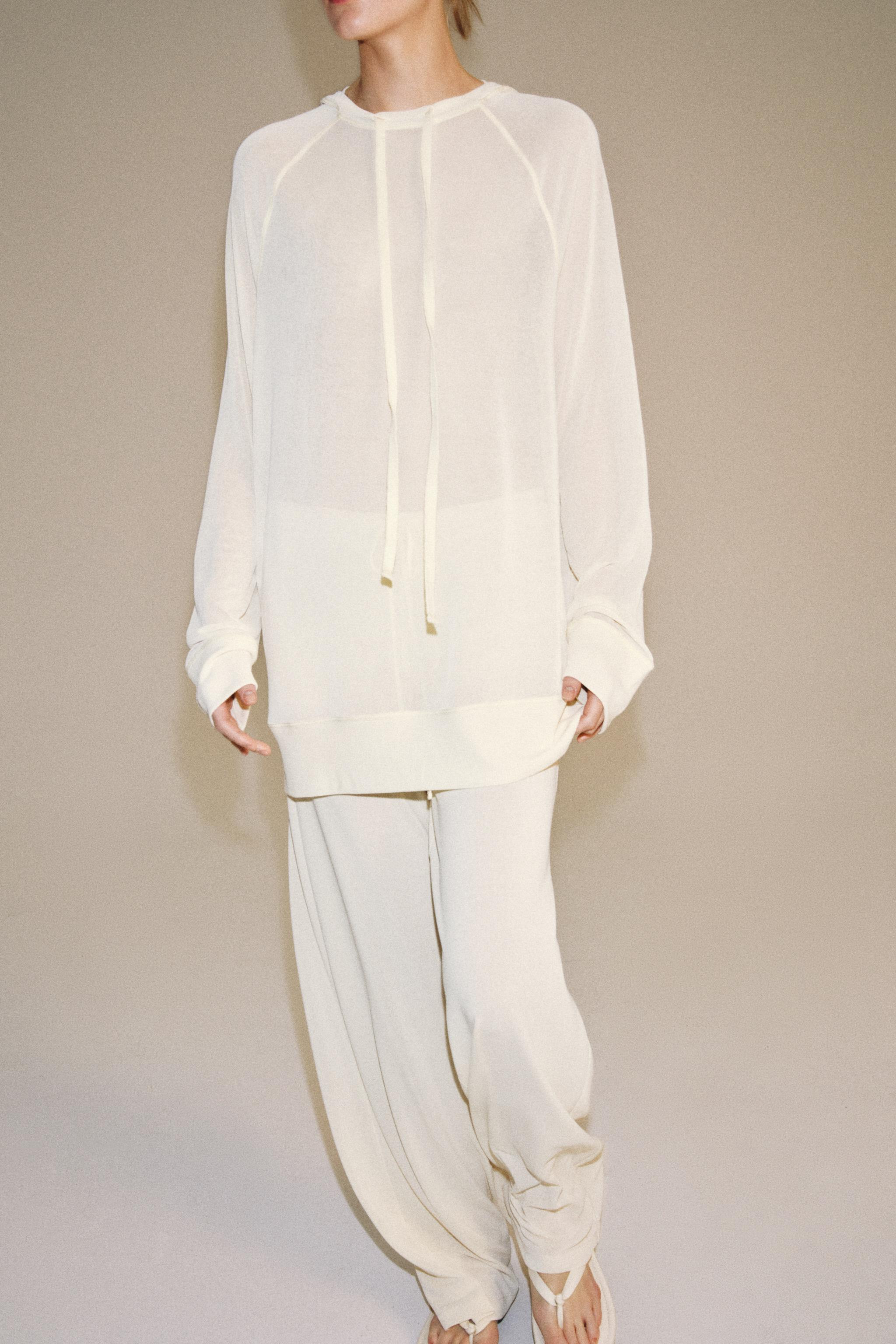 Model height: 176 cmTrousers crafted from a semi-sheer fabric. Mid-waist design with an adjustabl... | Zara UK