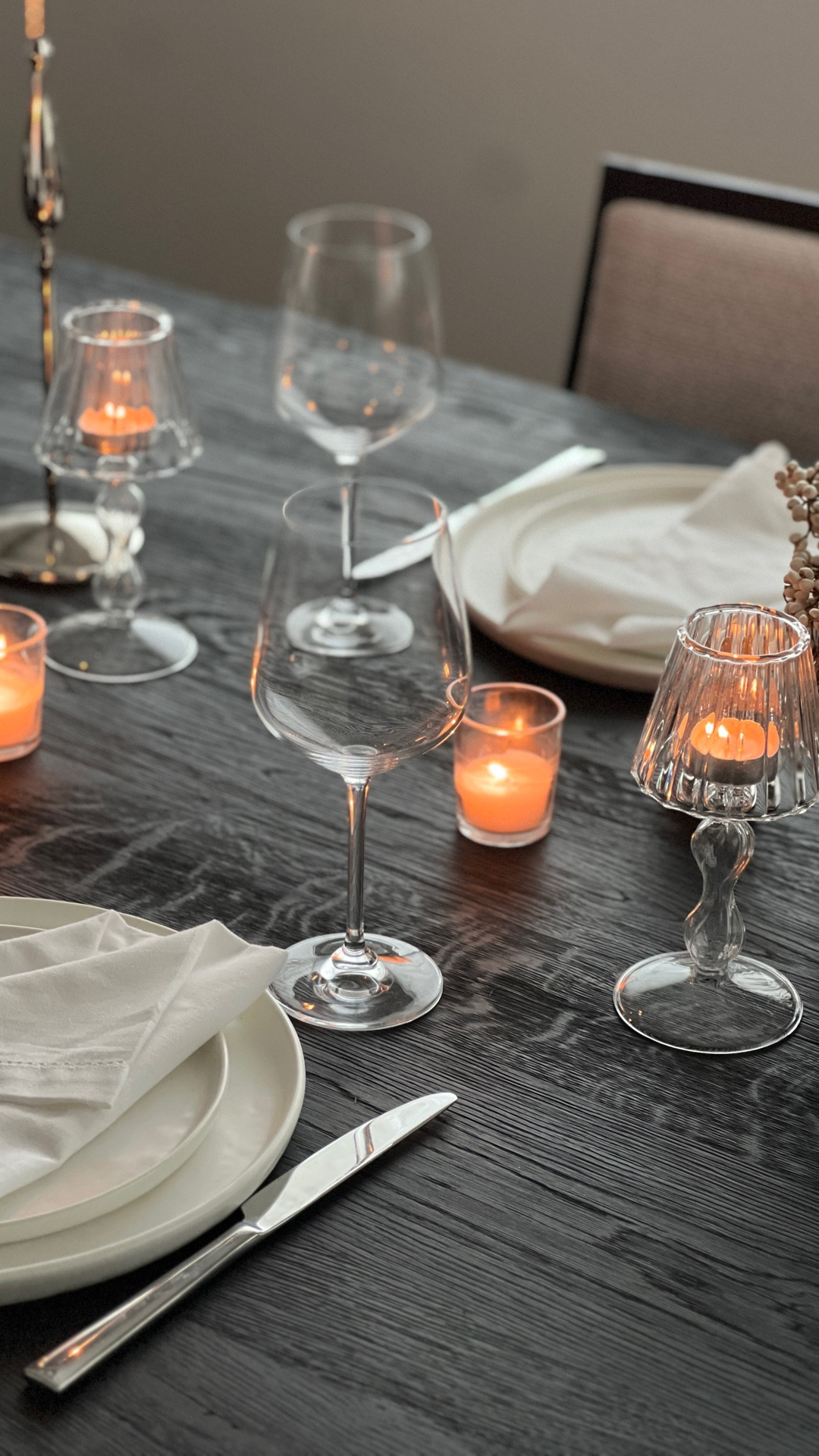Effortless black and white neutral date night table for two, blackened oak dining table, glass tealight lamps, organic ceramic white dinner plates, polished silver candle holders, white eyelet napkins, polished mirror silverware, neutral tablescape

#LTKHome