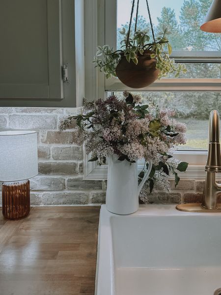Cottage Kitchen Summer Vibes | gold faucet | brick backsplash | farmhouse sink | hanging planter | lamp 