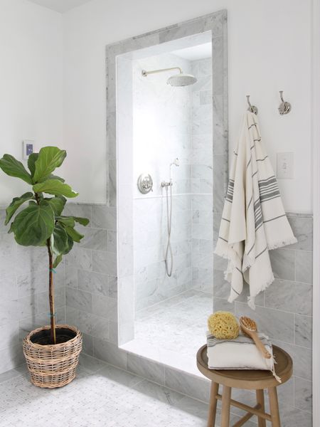 Originally this was a bathtub. When I remodeled the space I removed the tub and expanded the shower. I originally planned a glass door but decided against it and am glad I did. The open space works really well and I don’t miss having to clean a glass door.
All of the marble is Carrara. I included a rainfall shower head and hand shower  

#LTKstyletip #LTKFind #LTKhome