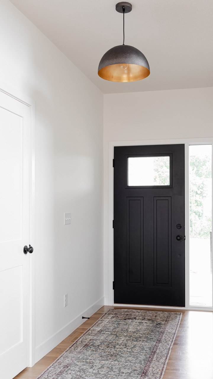 A simple entryway can still make a statement. We kept the palette neutral with white walls and  wood floors, then added contrast with a black front door and a vintage-style runner. The black and brass dome pendant light adds just enough drama—without overwhelming the space.

#LTKHome #LTKStyleTip #LTKFindsUnder100