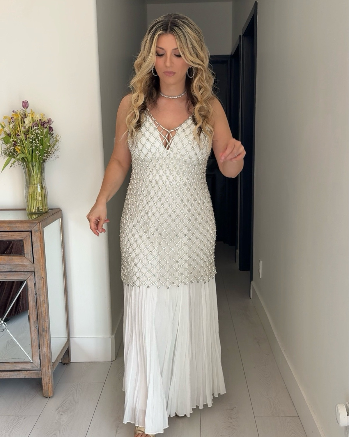 The pearl dress of my dreams! Don’t let the picture on the website fool you…it doesn’t do this dress any justice! It has a removable nude lining. Once you take that out, you can wear whatever color you like underneath. 
The perfect white beaded dress with crystals and long pearls woven to create the short dress. I added the white long skirt and bodysuit for this look, but you can wear it with any color underneath. 
Ideas: party dress for bride, Coachella or festival, engagement party, bridal shower, birthday gown

I’m 5’3 and 135lbs: wearing size 2 (which is a US 6 for this brand), skirt is a medium, bodysuit is a medium.

#LTKWedding #LTKOver40 #LTKPetite